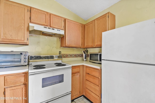 kitchen with white appliances, under cabinet range hood, light countertops, and a textured ceiling