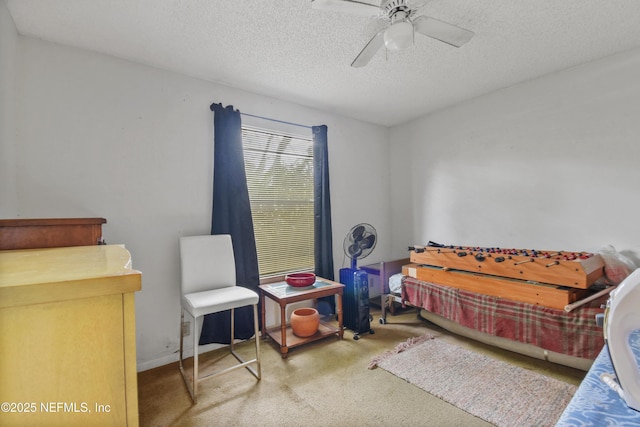 carpeted bedroom featuring ceiling fan, a textured ceiling, and baseboards