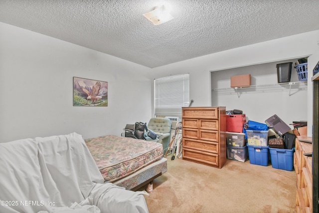 bedroom featuring a textured ceiling and carpet flooring