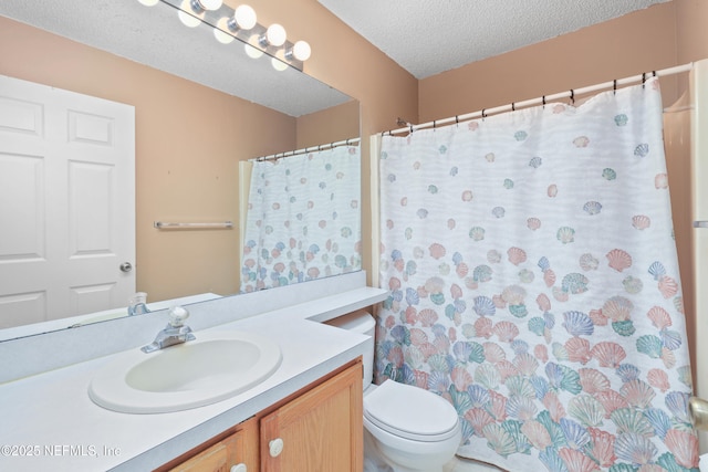 full bath featuring toilet, a textured ceiling, and vanity