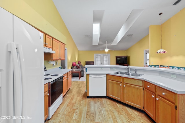 kitchen with light countertops, hanging light fixtures, open floor plan, white appliances, and under cabinet range hood