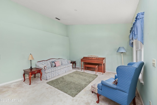 interior space with vaulted ceiling, carpet flooring, and baseboards