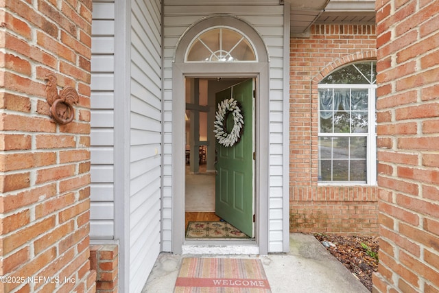 doorway to property with brick siding