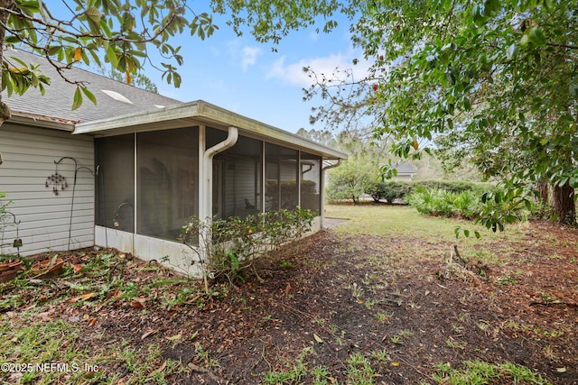 view of property exterior with a sunroom