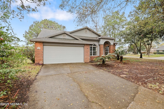 view of front of house with concrete driveway, brick siding, an attached garage, and roof with shingles