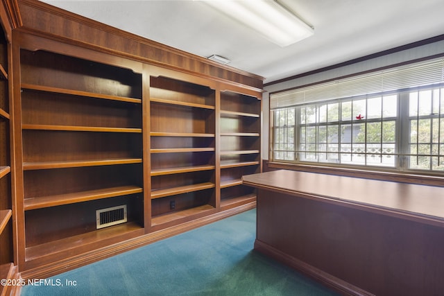 unfurnished office featuring a healthy amount of sunlight, visible vents, and dark carpet