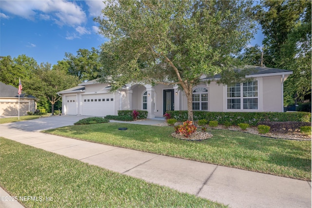 ranch-style house featuring a garage, driveway, a front lawn, and stucco siding