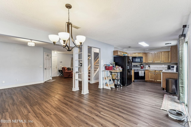 kitchen with open floor plan, dark wood-style flooring, decorative light fixtures, light countertops, and black appliances