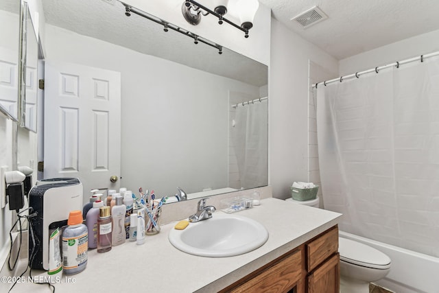 full bathroom with shower / tub combo, visible vents, toilet, a textured ceiling, and vanity