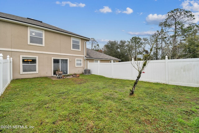 rear view of property featuring central AC unit, a lawn, a patio, a fenced backyard, and stucco siding