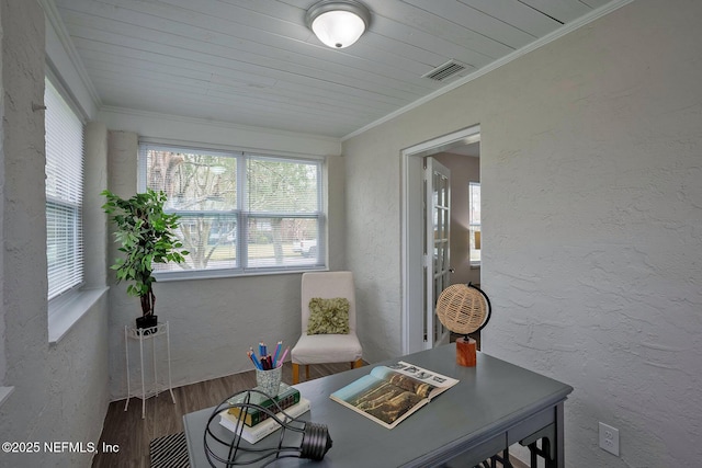 sitting room featuring a textured wall, wood finished floors, wood ceiling, visible vents, and crown molding