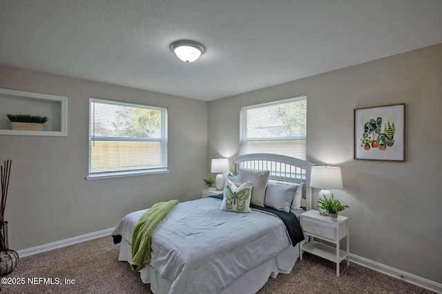 carpeted bedroom with multiple windows, baseboards, and a textured ceiling