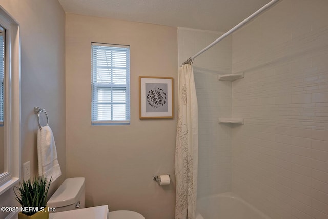 bathroom with shower / bath combination with curtain and toilet