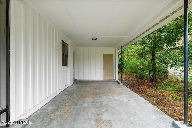 view of patio / terrace featuring a carport and fence