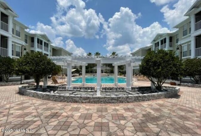 community pool featuring a pergola