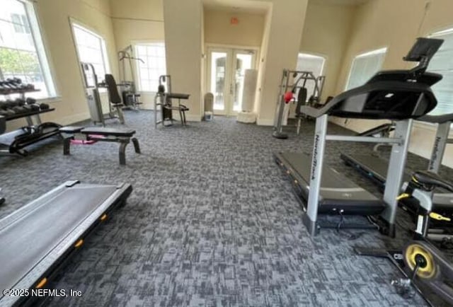 workout area with dark colored carpet, french doors, and baseboards