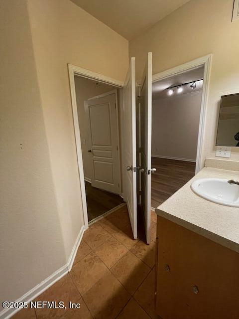 bathroom with tile patterned flooring, vanity, and baseboards