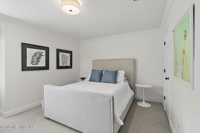 bedroom featuring light carpet, baseboards, ornamental molding, and a textured ceiling