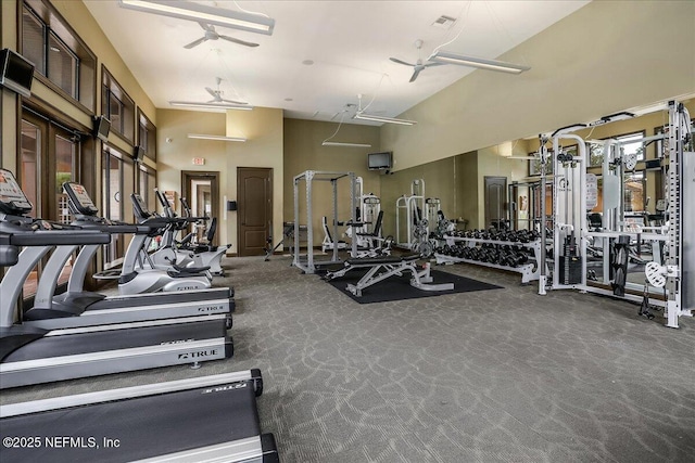 workout area featuring a high ceiling and a ceiling fan