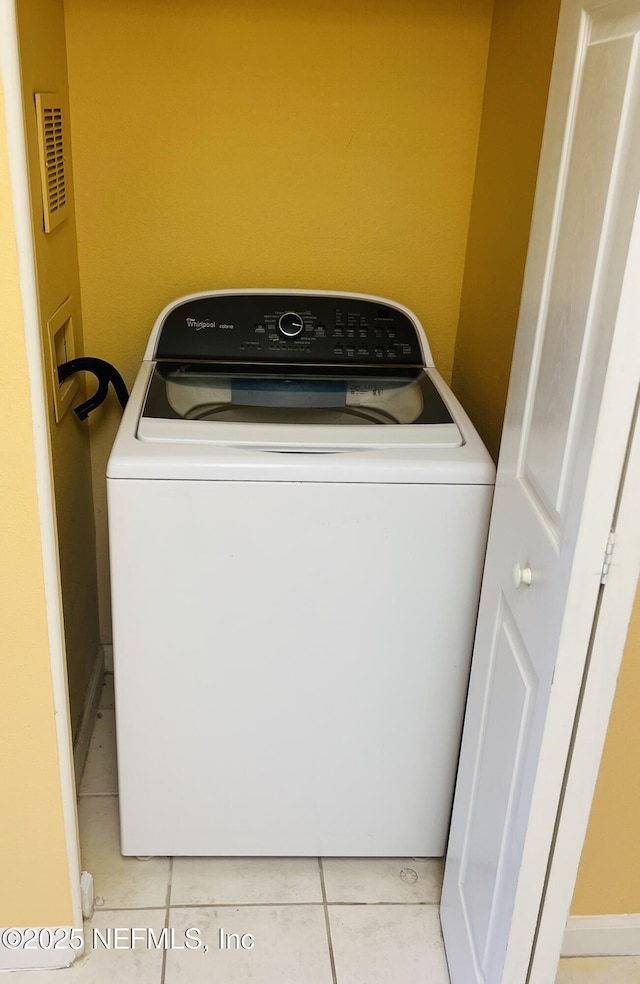 laundry room with laundry area, light tile patterned floors, and washer / clothes dryer