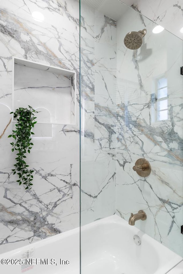 bathroom featuring washtub / shower combination