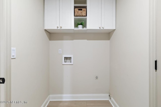 laundry room featuring hookup for a washing machine, light wood-style floors, baseboards, cabinet space, and electric dryer hookup