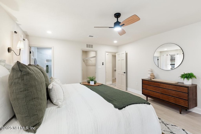 bedroom with baseboards, light wood-type flooring, visible vents, and recessed lighting