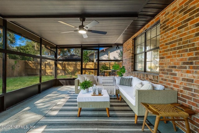 unfurnished sunroom with ceiling fan