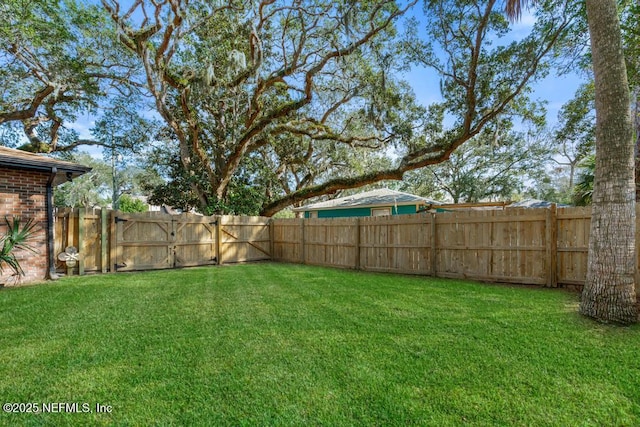 view of yard with a fenced backyard