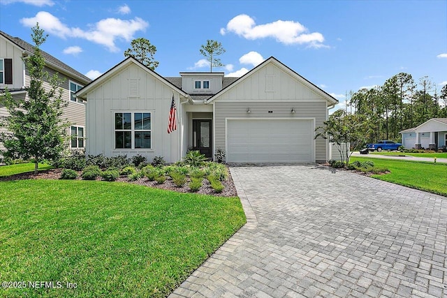 view of front facade with a garage, decorative driveway, a front lawn, and board and batten siding