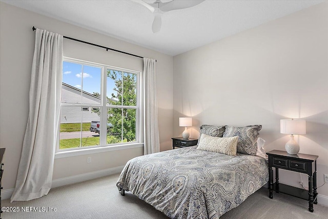 carpeted bedroom with a ceiling fan and baseboards