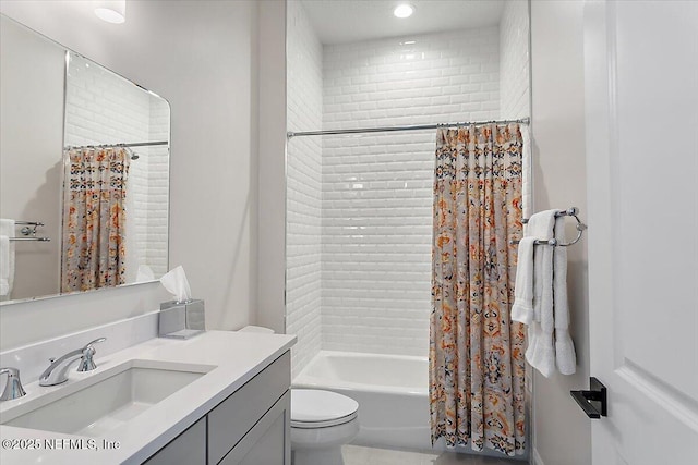 full bathroom featuring shower / tub combo, vanity, and toilet