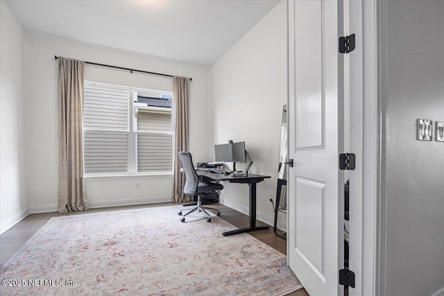 office featuring baseboards and wood finished floors