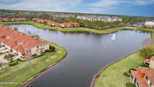 drone / aerial view featuring a water view and a residential view