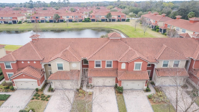 bird's eye view featuring a water view and a residential view