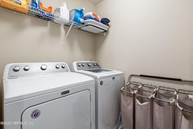 washroom featuring laundry area and washing machine and clothes dryer