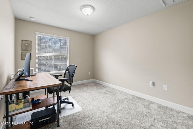 carpeted office space with visible vents and baseboards