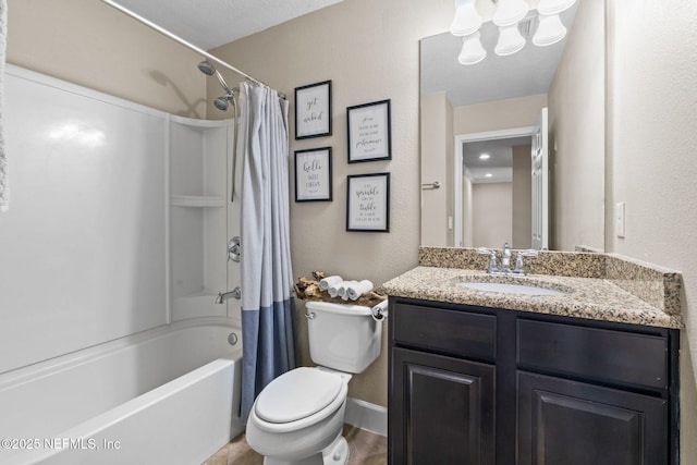 full bath with shower / bath combo, baseboards, a textured wall, toilet, and vanity