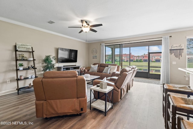 living area featuring crown molding, visible vents, ceiling fan, and wood finished floors