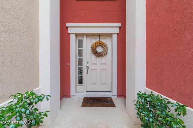 property entrance featuring stucco siding