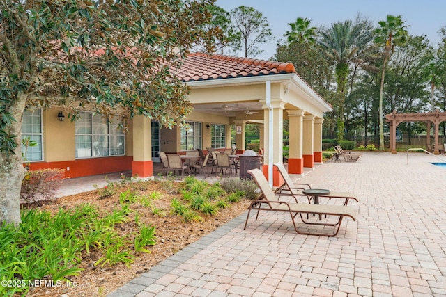 view of patio / terrace featuring ceiling fan and a pergola