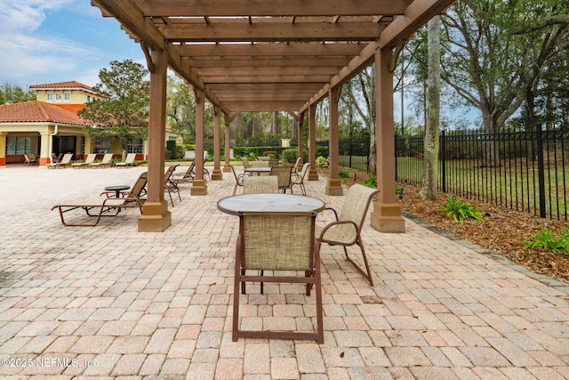 view of patio / terrace with outdoor dining space, fence, and a pergola