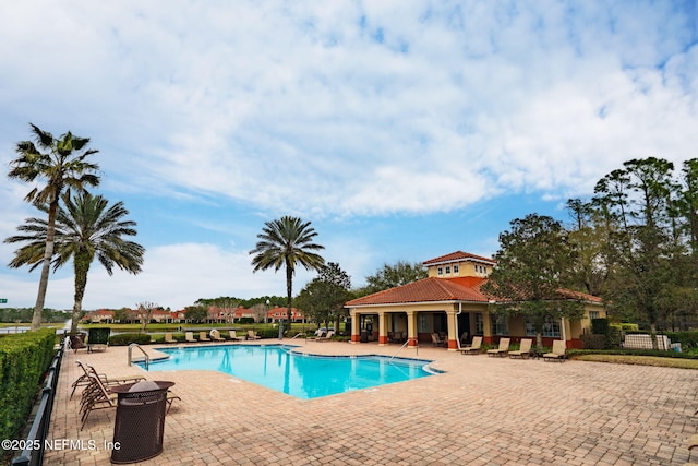 pool with fence and a patio