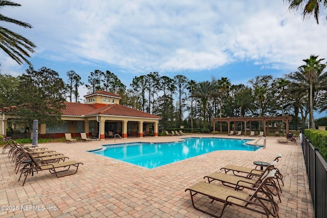 community pool featuring a patio area, fence, and a pergola