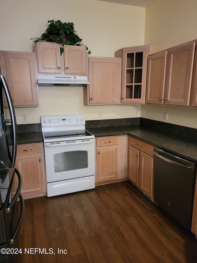 kitchen featuring dark countertops, dishwasher, under cabinet range hood, and electric stove