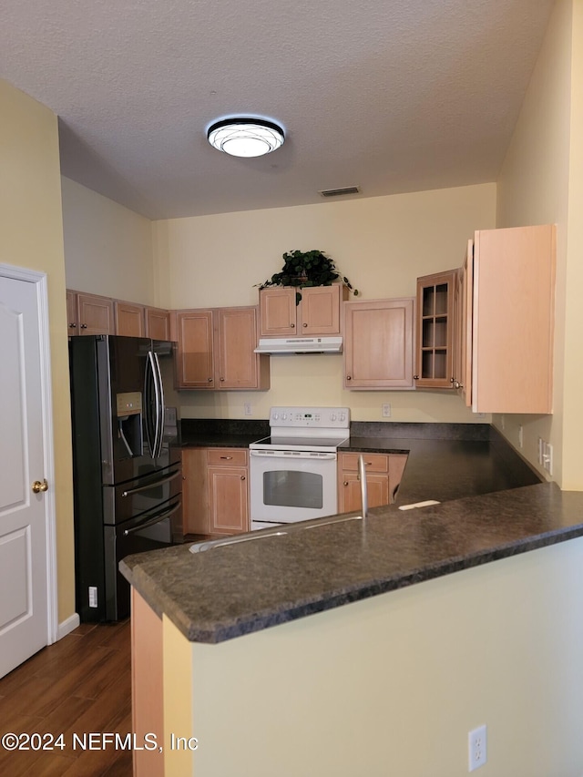 kitchen featuring white electric range oven, dark countertops, black refrigerator with ice dispenser, glass insert cabinets, and a peninsula