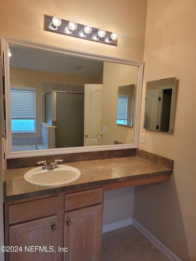 full bath with a garden tub, a shower stall, and vanity