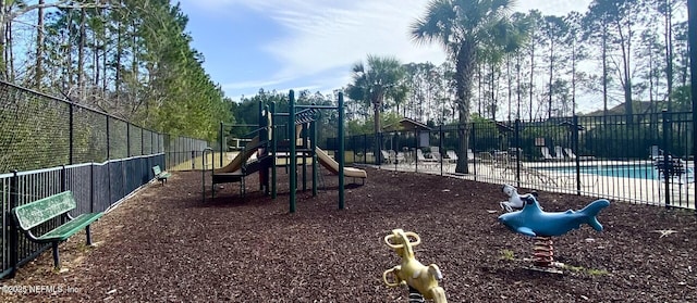 community play area featuring a community pool and fence