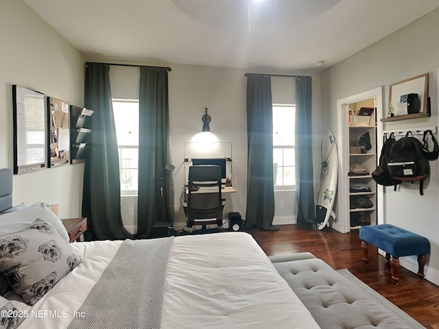 bedroom featuring baseboards and wood finished floors