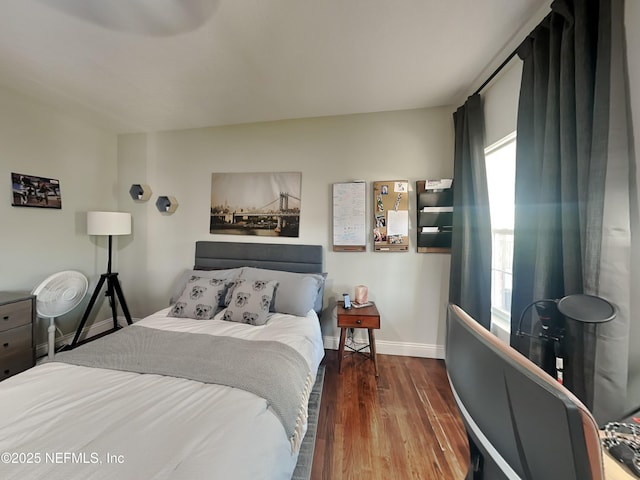 bedroom featuring baseboards and wood finished floors